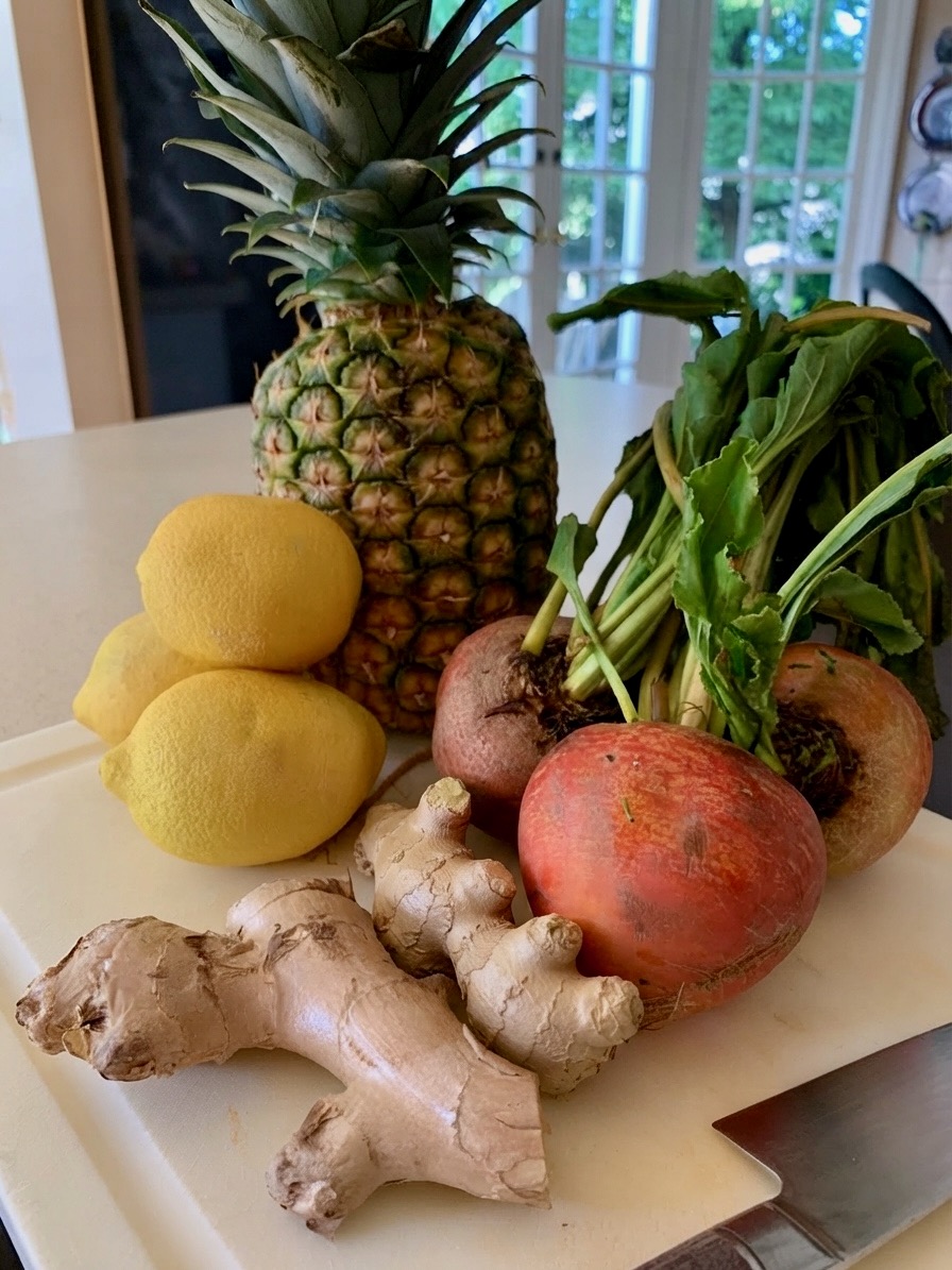 Fresh organic produce — pineapple, lemons, beets, ginger